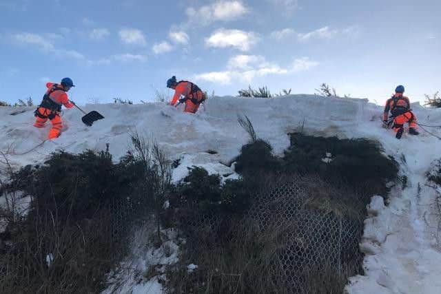 Network Rail abseilers clearing the threatened avalanche. Picture: ScotRail Alliance