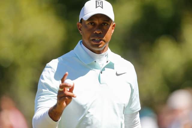 Tiger Woods reacts after holing a putt on the eighth hole. Picture: Michael Reaves/Getty Images