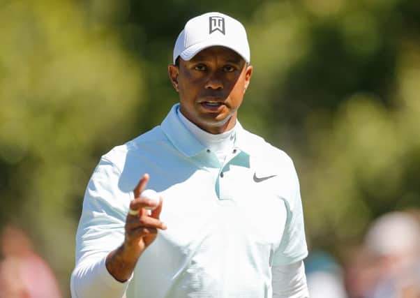 Tiger Woods reacts after holing a putt on the eighth hole. Picture: Michael Reaves/Getty Images