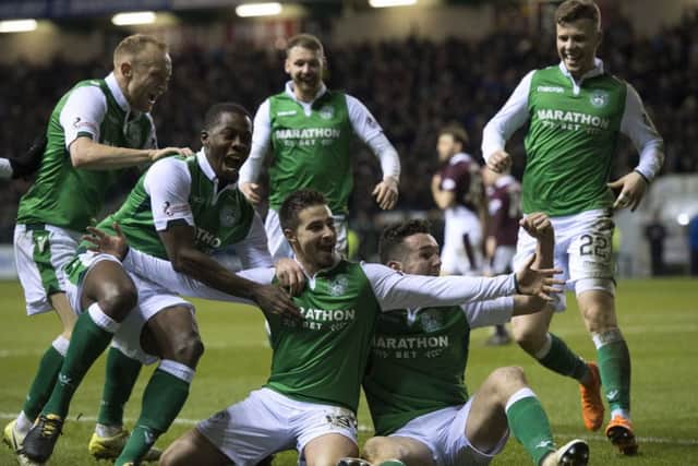 Hibs players mob
Jamie Maclaren, centre, after the Australian's goal clinched a 2-0 win over Hearts at Easter Road. Picture: Ross Parker/SNS