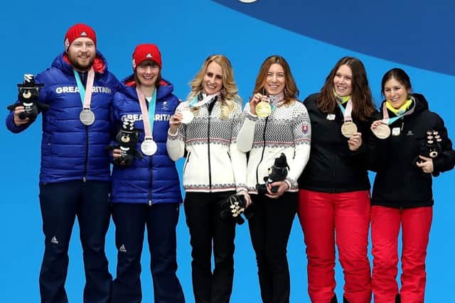 Brett Wild, far left, and Millie Knight on the podium with their silver medals. Picture: Getty.