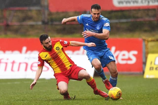 Andrew Considine looks to manoeuvre around Partick Thistle midfielder Steven Lawless. Picture: SNS