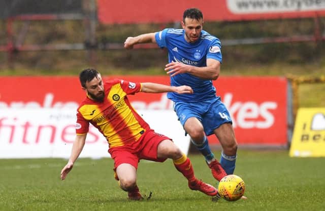 Andrew Considine looks to manoeuvre around Partick Thistle midfielder Steven Lawless. Picture: SNS