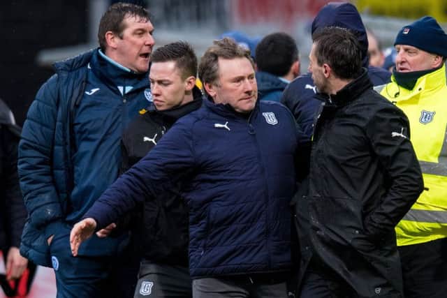 Neil McCann is led away after becoming embroiled in a touchline spat with St Johnstone goalkeeper Zander Clark. Picture: SNS
