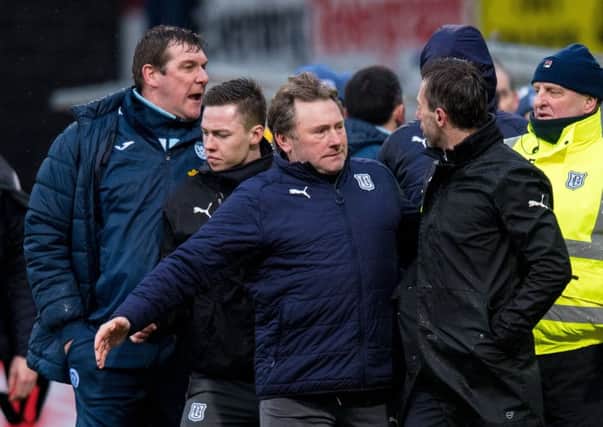 Neil McCann is led away after becoming embroiled in a touchline spat with St Johnstone goalkeeper Zander Clark. Picture: SNS