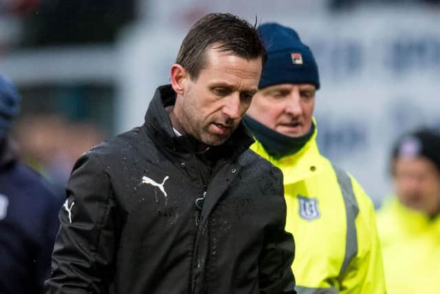A very unhappy Neil McCann trudges along the Dens Park track following the altercation at full-time. Picture: SNS.