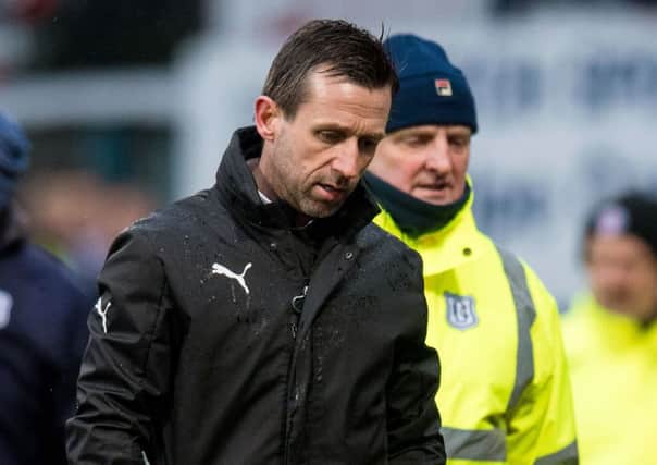 A very unhappy Neil  McCann trudges along the Dens Park track following the altercation at full-time. Picture: SNS.