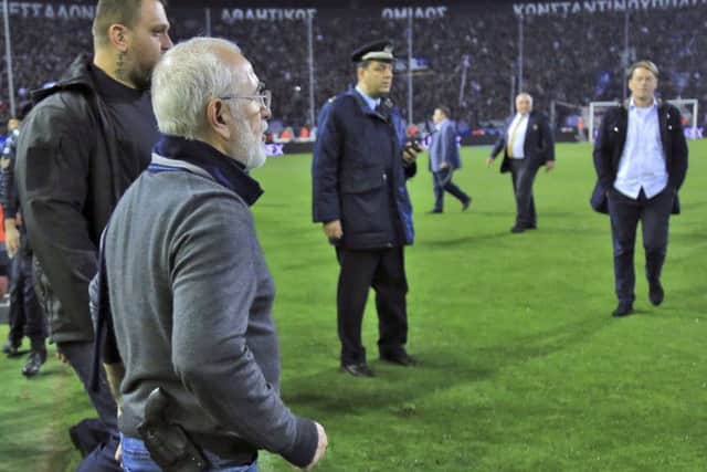 Savvidis, clearly carrying a gun in a hip holster, marches on to the pitch at the Toumba Stadium. Picture: AP