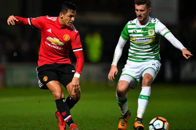 Tom James, right, going up against Alexis Sanchez of Manchester United in an FA Cup tie earlier this year. Picture: Getty