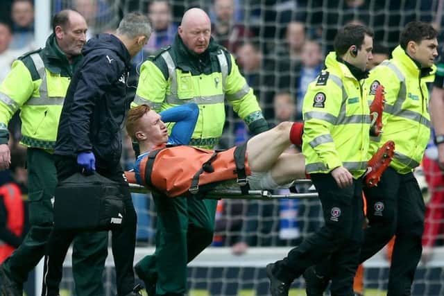David Bates is stretchered off during the first half of Rangers' loss to Celtic. Picture: PA