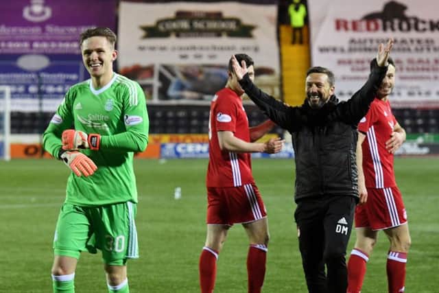 Aberdeen's Freddie Woodman celebrates the Scottish Cup win over Kilmarnock with manager Derek McInnes. Picture: Craig Williamson/SNS