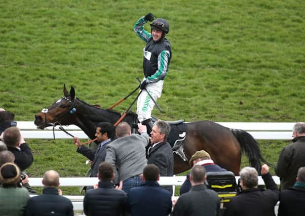 Jockey Nico De Boinville celebrates after Altior's victory in the Champion Chase