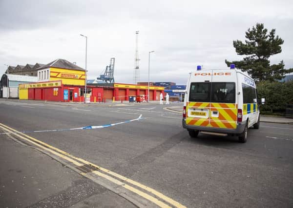 Police seal off the scene of the incident in Greenock. Picture: SWNS