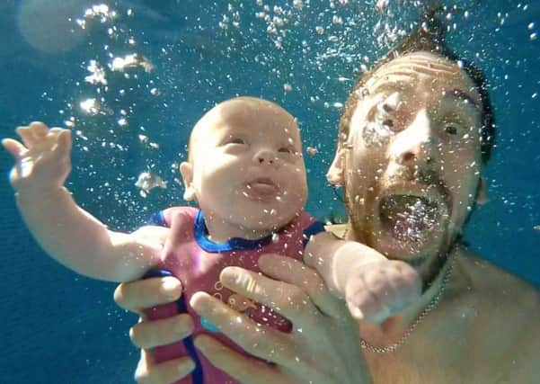 Four month old Mara Wasik who, after a tough start in life, is mastering the art of free diving.
She is pictured with dad, Shane. Picture: Nikki Wasik.