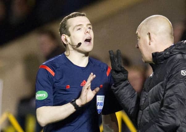 Rangers manager Mark Warburton (centre) speaks with Douglas Ross MP in his role as linesman. Picture: SNS