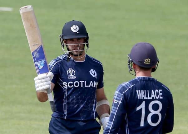 Kyle Coetzer raises his bat after reaching 50 against Nepal in the group stage of the tournament. Picture: ICC/Getty