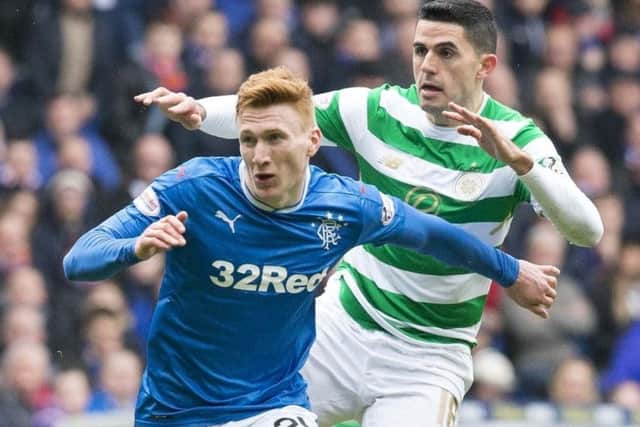 David Bates battles for the ball with Tom Rogic during last week's Old Firm clash at Ibrox. Picture: PA