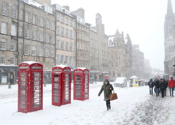 A woman makes her way through the snow up Edinburgh's Royal Mile. Picture: Jane Barlow/PA Wire