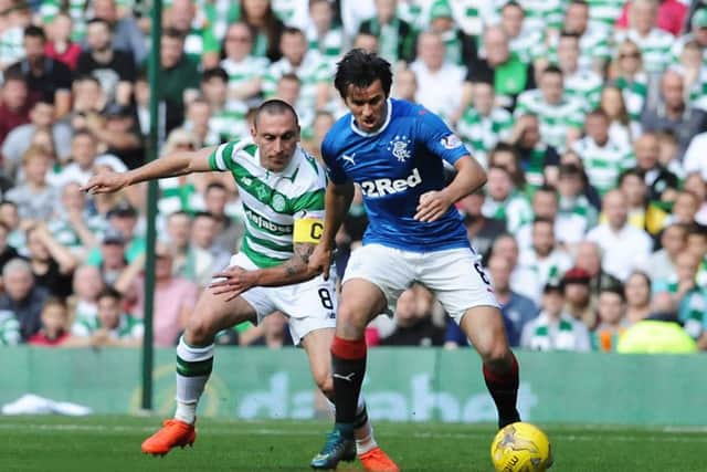 Barton and Brown battle it out in an Old Firm match in September 2016 - one of just eight appearances Barton managed for the Ibrox side. Picture: John Devlin