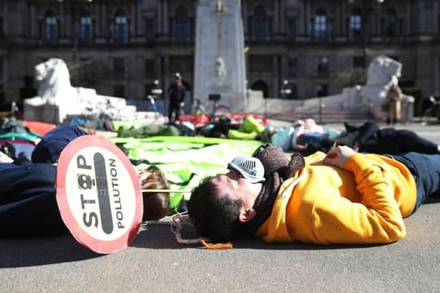 Campaigners staged a "die-in" at George Square in Glasgow today in protest at the restrictions taking four years to complete. Picture: Friends of the Earth Scotland