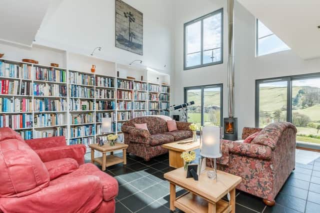 The living area of Bitstone House, near Hawick, is double-height and has fitted bookshelves. Pic: Pic: Strutt & Parker
