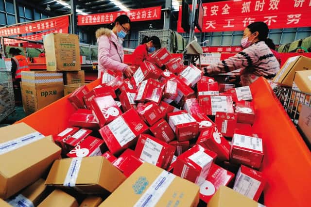 Workers prepare boxes for packaging goods for delivery at a sorting center in Lianyungang, Jiangsu province during the Singles Day online shopping festival. Photo: Getty Images