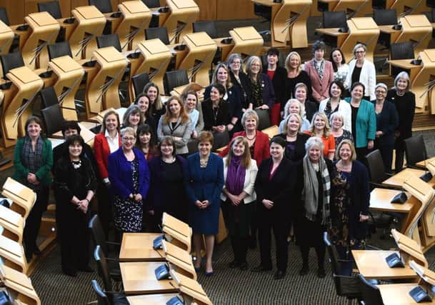 Female Scottish MSPs gather at Holyrood to celebrate the 100-year anniversary of women over 30 getting the vote. Picture: Lisa Ferguson