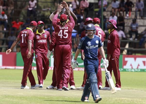 West Indies players celebrate the wicket of Scotland batsman Mathew Cross. Picture: Tsvangirayi Mukwazhi/AP
