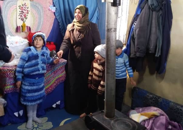 Above, inside a makeshift refugee home.