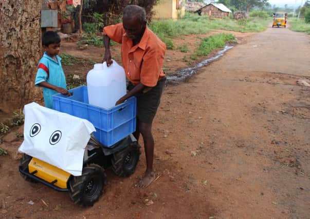 A four wheeled robot named Husky helps villagers in Ayyampathy, southern India, carry waterDeshmukh.