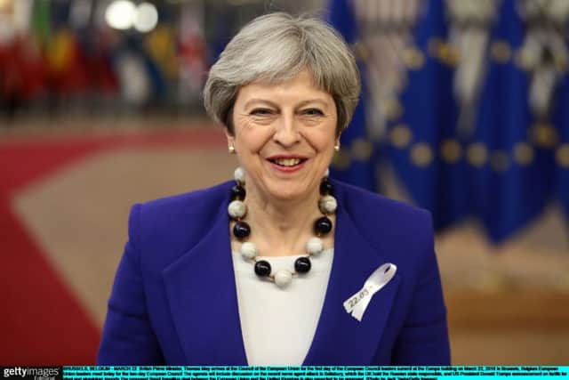 British Prime Minister Theresa May arrives at the Council of the European Union wearing a white ribbon in commemoration of terror attacks in Westminster and Brussels. Picture: Jack Taylor/Getty Images
