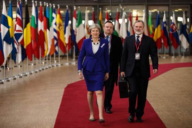 Theresa May (L) arrives at the Council of the European Union.(Photo by Jack Taylor/Getty Images)