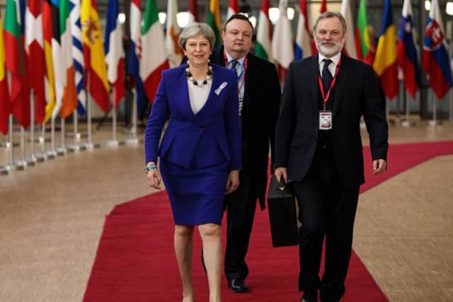 British Prime Minister Theresa May (L) arrives at the Council of the European Union..(Photo by Jack Taylor/Getty Images)