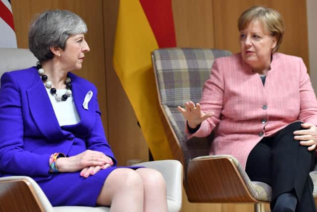 British Prime Minister Theresa May (L) and German Chancellor Angela Merkel (R). Pic: AFP/Getty