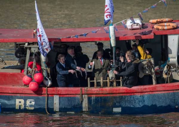 Nigel Farage and Fishing for Leave supporters throw fish into the Thames. Picture: Chris J Ratcliffe/Getty