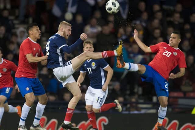 Scotland's Oli McBurnie competes with Costa Rica's David Guzman. Picture: SNS/Alan Harvey