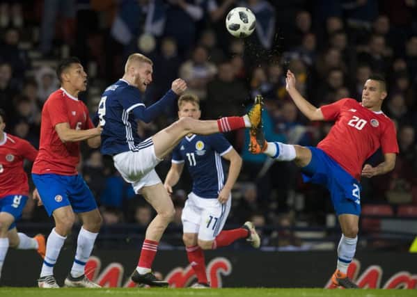 Scotland's Oli McBurnie competes with Costa Rica's David Guzman. Picture: SNS/Alan Harvey