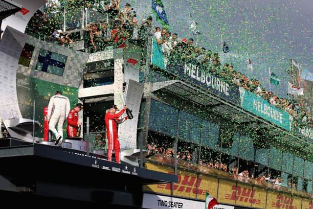 Sebastian Vettel celebrates on the podium in Melbourne and kisses the trophy after winning the opening grand prix of the 2018 season. Picture: Getty.