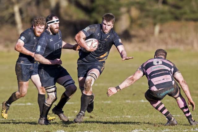 Curries Hamish Bain takes on Blair Macpherson of Ayr during the west of Scotland sides 24-21 victory yesterday. Picture: SNS.