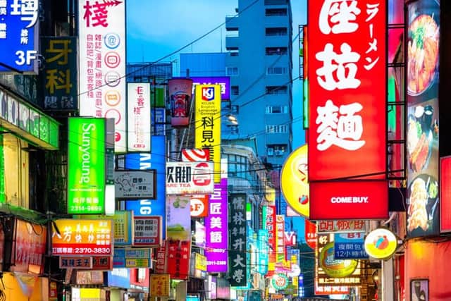 The streets of Taipei at dusk are a riot of neon signs