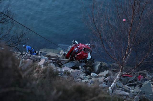 A Honda Civic that crashed off the A832 at Ardessie and ended up in Little Loch Broom has left two people deal. Picture: Peter Jolly