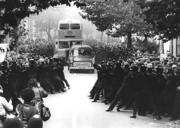 Police restrain demonstrators as the work bus arrives at Grunwick photo-processing laboratory in Willesden, London, in 1977. (Picture: Getty)