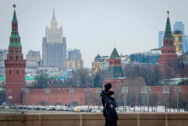 Police officials patrols on a bridge outside The Kremlin in Moscow. Pic: AFP/Getty