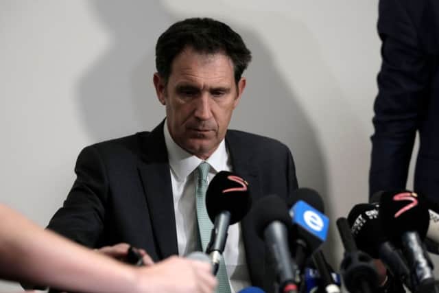 A grim-faced James Sutherland, chief executive of Cricket Australia, faces the press in Johannesburg.