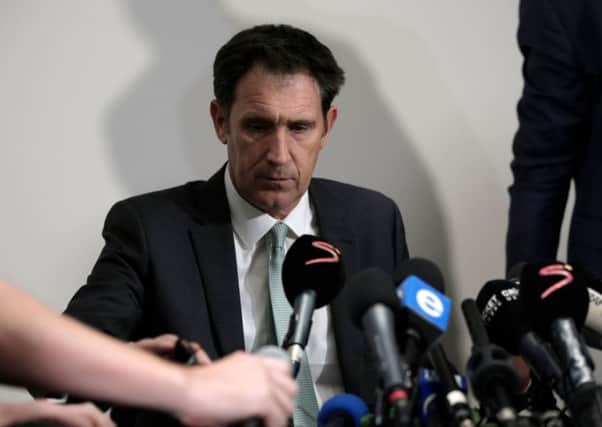 A grim-faced James Sutherland, chief executive of Cricket Australia, faces the press in Johannesburg.