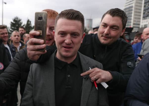 Tommy Robinson (centre) has been suspended from Twitter. Picture: Aaron Chown/PA Wire