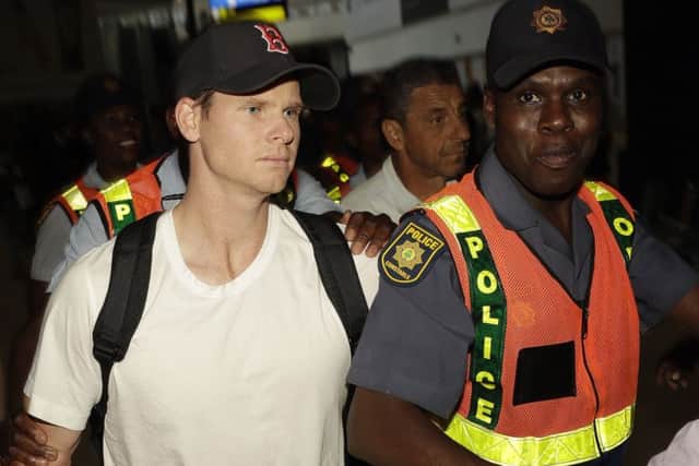 Former Australia captain Steve Smith is escorted by police at Johannesburg airport. Picture: Themba Hadebe/AP