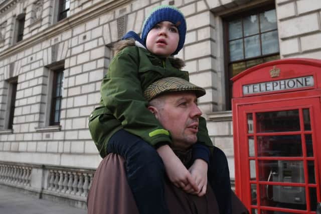 Six-year-old Alfie Dingley is carried by his father Drew Dingley along Whitehall in London before handing in a petition to Number 10 Downing Street asking for Alfie to be given medicinal cannabis to treat his epilepsy.