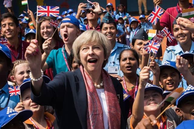 Theresa May, seen waving a Union Jack during a visit to Bangalore, India, insists Brexit can be a success, for example by enabling the UK to make its own trade deals with other countries. (Picture: Getty)