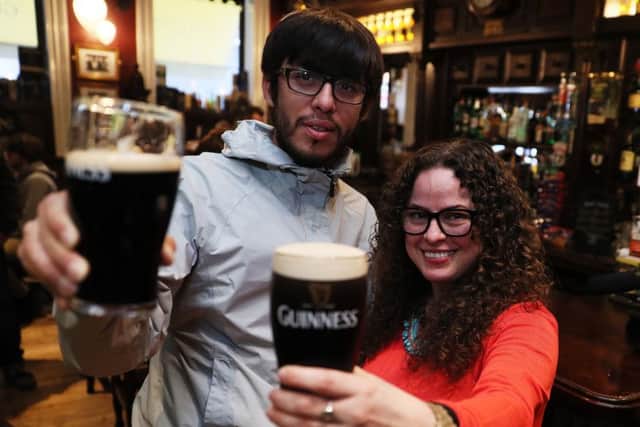 Students Juan Pizarro (left), from Chile, and Yadira Perez, from Mexico, enjoying a drink in Slattery's Bar on Capel street in Dublin. Pic: PA Wire